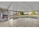 Enclosed patio features tile flooring and view to the backyard at 1409 Overlake Ave, Orlando, FL 32806