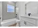 Well-lit bathroom showcasing a bathtub and shower with modern fixtures, next to the vanity and toilet at 142 Guava Pass, Ocklawaha, FL 32179
