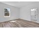 Bright bedroom with luxury vinyl flooring and natural light, adjoining the bathroom at 142 Guava Pass, Ocklawaha, FL 32179
