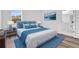 Bedroom with bed, lamps, artwork, and ensuite bathroom with vanity at 142 Guava Pass, Ocklawaha, FL 32179