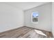 Minimalist bedroom design with luxury vinyl flooring and natural light at 142 Guava Pass, Ocklawaha, FL 32179