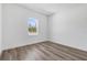 Well-lit bedroom features luxury vinyl flooring and natural light from a single window at 142 Guava Pass, Ocklawaha, FL 32179
