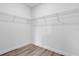 Walk-in closet featuring vinyl flooring and white wire shelving system for easy organization at 142 Guava Pass, Ocklawaha, FL 32179