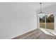 Dining area with modern lighting, wood-style flooring, and sliding glass doors at 142 Guava Pass, Ocklawaha, FL 32179