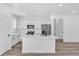 Modern kitchen with a center island, stainless steel appliances, and a view to the entry at 142 Guava Pass, Ocklawaha, FL 32179