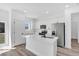 Bright kitchen featuring an island, stainless steel appliances, and white cabinetry at 142 Guava Pass, Ocklawaha, FL 32179