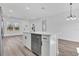 Bright, open-concept kitchen featuring a central island, stainless steel appliances, and modern finishes at 142 Guava Pass, Ocklawaha, FL 32179