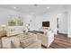 Bright living room featuring hardwood floors and large windows at 142 Guava Pass, Ocklawaha, FL 32179