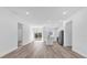 Open-concept living space featuring modern wood floors, stainless steel appliances, and plenty of natural light at 142 Guava Pass, Ocklawaha, FL 32179