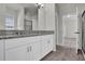 Bathroom with double sinks, granite countertops, and a shower at 18058 Cider Mill Ln, Winter Garden, FL 34787