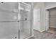 Modern bathroom features a tiled shower with glass enclosure and wood-look tile flooring at 18058 Cider Mill Ln, Winter Garden, FL 34787