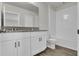 Bathroom featuring vanity with granite countertops, white cabinets and a shower-tub combo at 18058 Cider Mill Ln, Winter Garden, FL 34787