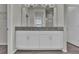 Bathroom featuring a double vanity with granite countertop and white cabinets at 18058 Cider Mill Ln, Winter Garden, FL 34787