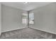 Bedroom with neutral carpet, walls and two windows, providing great natural light at 18058 Cider Mill Ln, Winter Garden, FL 34787