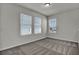 Bedroom featuring neutral colored walls, carpet, and multiple windows at 18058 Cider Mill Ln, Winter Garden, FL 34787