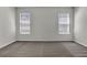 Bedroom featuring neutral carpeting, light-colored walls, and two windows at 18058 Cider Mill Ln, Winter Garden, FL 34787