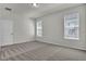 Bedroom featuring neutral carpeting, light-colored walls, a ceiling light, and two windows at 18058 Cider Mill Ln, Winter Garden, FL 34787