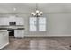 Bright dining space featuring an elegant chandelier, windows with natural light, and modern kitchen views at 18058 Cider Mill Ln, Winter Garden, FL 34787