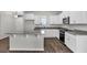 Well-equipped kitchen featuring stainless steel appliances, granite countertops, white cabinets, and a functional island design at 18058 Cider Mill Ln, Winter Garden, FL 34787