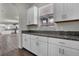 Kitchen area featuring white cabinets, granite countertops, and stainless steel pulls at 18058 Cider Mill Ln, Winter Garden, FL 34787