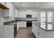 Modern kitchen featuring white cabinets, granite countertops, stainless steel appliances, and an island with bar seating at 18058 Cider Mill Ln, Winter Garden, FL 34787