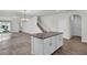 Spacious living area showcasing tile floors, an open layout, and a kitchen island with barstool seating at 18058 Cider Mill Ln, Winter Garden, FL 34787