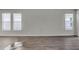 Spacious living room with light-colored walls, white trim, and two large windows at 18058 Cider Mill Ln, Winter Garden, FL 34787