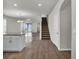 Bright, open-concept living area featuring tile flooring, neutral paint, and an adjacent staircase leading to the upper level at 18058 Cider Mill Ln, Winter Garden, FL 34787