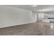 Open-concept living area showcasing wood-look tile flooring and a view of the staircase and kitchen at 18058 Cider Mill Ln, Winter Garden, FL 34787