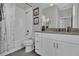 Bathroom featuring marble shower curtain, white vanity with granite top, and modern fixtures at 18076 Cider Mill Ln, Winter Garden, FL 34787