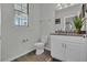 Well-lit bathroom with granite vanity top, stylish fixtures, and a window providing natural light at 18076 Cider Mill Ln, Winter Garden, FL 34787