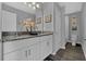 Bright bathroom features a granite double sink vanity, decor accents, and modern grey and white color scheme at 18076 Cider Mill Ln, Winter Garden, FL 34787