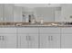 Elegant bathroom with granite countertop and double vanity sinks below a large mirror at 18076 Cider Mill Ln, Winter Garden, FL 34787