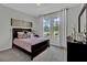 Comfortable bedroom filled with natural light, carpeted floors, and a serene color palette at 18076 Cider Mill Ln, Winter Garden, FL 34787