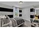 Stylized bedroom with black and gray horizontal stripes, plush carpet, and a cozy, patterned duvet cover at 18076 Cider Mill Ln, Winter Garden, FL 34787