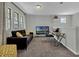 Cozy bonus room with a seating area, desk, and large windows for natural light at 18076 Cider Mill Ln, Winter Garden, FL 34787