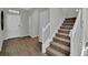 Welcoming entryway leads to carpeted stairs, offering a glimpse of the home's layout and design elements at 18076 Cider Mill Ln, Winter Garden, FL 34787