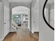 Bright entryway featuring hardwood floors, arched doorways, and staircase that leads to an open-concept living area at 18076 Cider Mill Ln, Winter Garden, FL 34787