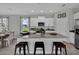 Modern kitchen featuring a large granite island with seating, stainless steel appliances, and natural light at 18076 Cider Mill Ln, Winter Garden, FL 34787