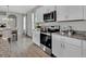 Well-lit kitchen with stainless steel appliances, granite countertops, and a view into the dining area at 18076 Cider Mill Ln, Winter Garden, FL 34787