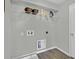 Functional laundry room with overhead shelving for storage solutions and washer/dryer hookups at 18076 Cider Mill Ln, Winter Garden, FL 34787