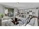Spacious living room with ample seating, sliding doors to patio, and seamless flow into kitchen at 18076 Cider Mill Ln, Winter Garden, FL 34787