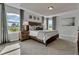 Serene bedroom with tray ceilings, scenic views from the large windows, and soft, neutral tones at 18076 Cider Mill Ln, Winter Garden, FL 34787