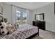 Serene main bedroom features soft decor, large windows, and a view of the green outdoors at 18076 Cider Mill Ln, Winter Garden, FL 34787