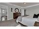 Tranquil bedroom with dark wood dresser, a round mirror, and an open view of the ensuite bathroom at 18076 Cider Mill Ln, Winter Garden, FL 34787