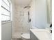 Bathroom featuring shower with marble-look tile and vanity with faucet and sink at 1905 Diamond Dr, Orlando, FL 32807