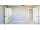 A spacious bedroom with tiled floors, white trim, and doors to other rooms at 1905 Diamond Dr, Orlando, FL 32807