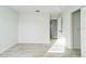 A spacious bedroom with tiled floors, white trim, and doors to other rooms at 1905 Diamond Dr, Orlando, FL 32807