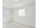 A sunlit bedroom with tiled floors and views to the outside at 1905 Diamond Dr, Orlando, FL 32807