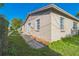 View of property exterior showing block construction, lawn, and sliding glass door at 1905 Diamond Dr, Orlando, FL 32807